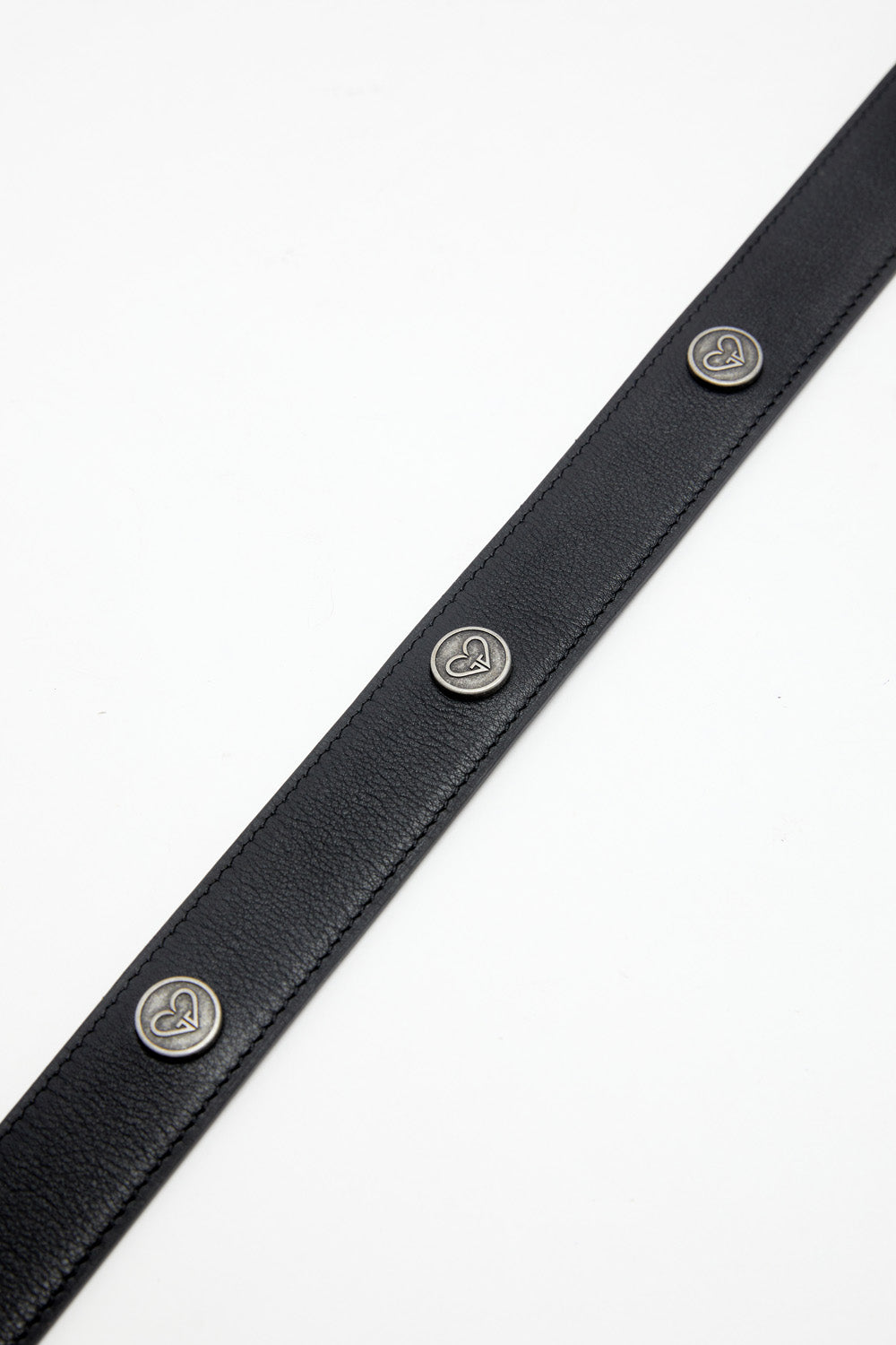 Black leather belt with silver heart-shaped buttons on a white background