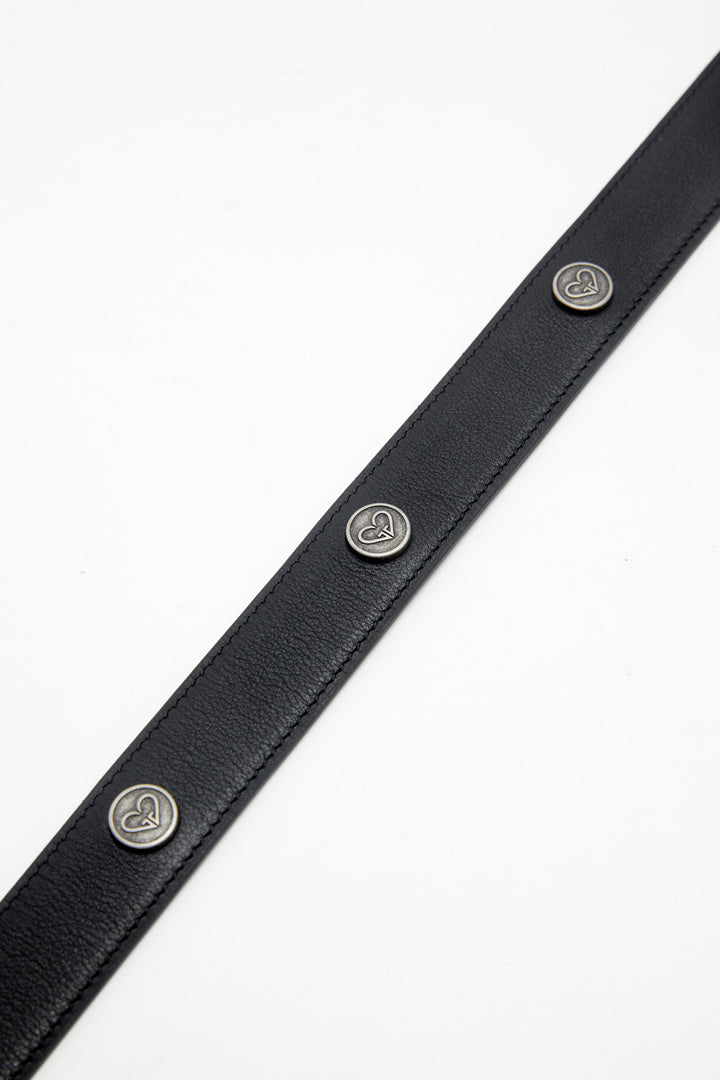 Black leather belt with silver heart-shaped buttons on a white background
