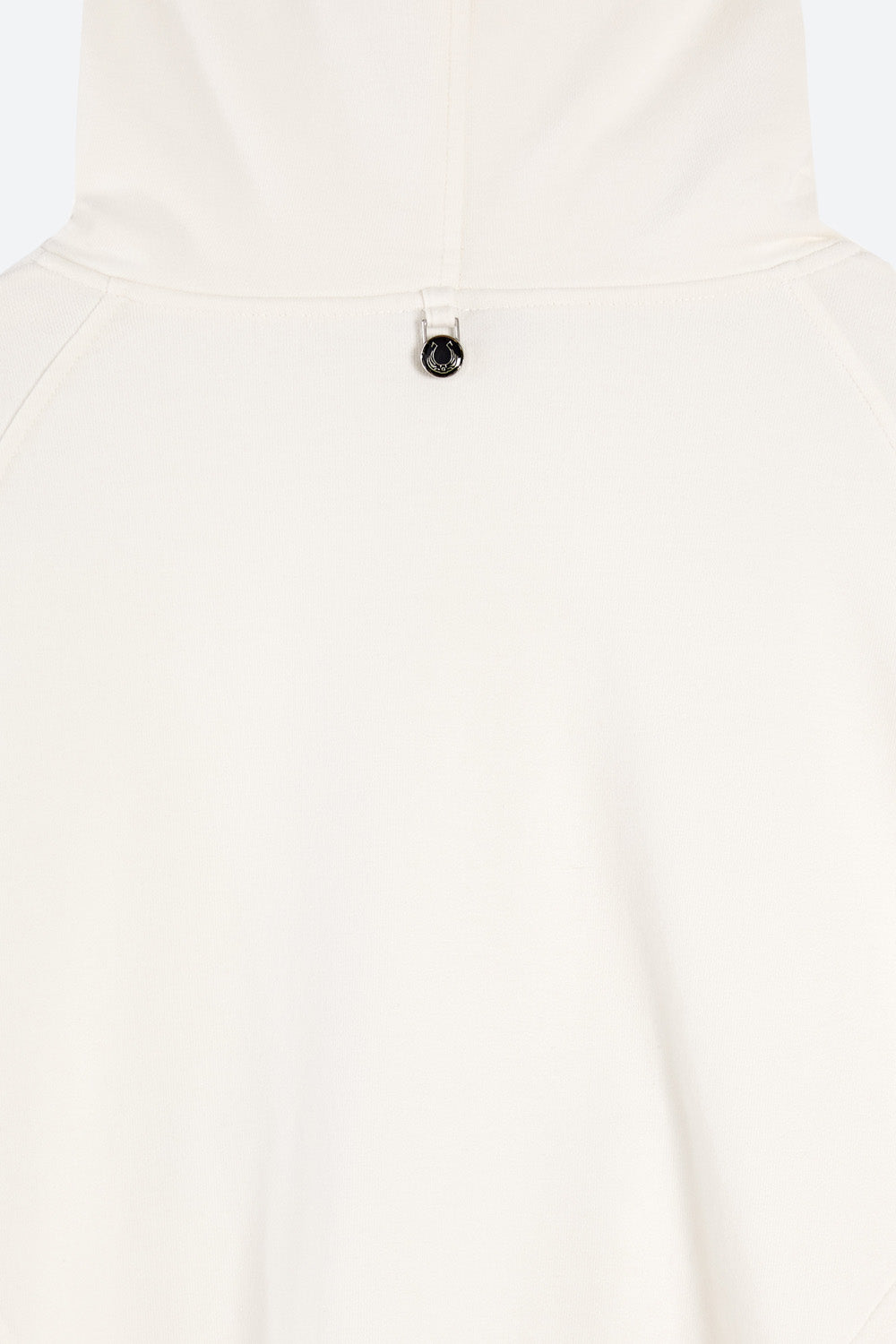 Close-up of a white shirt with a button on a light gray background