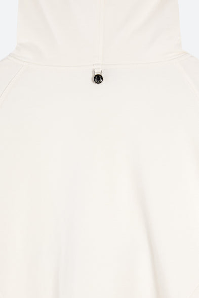 Close-up of a white shirt with a button on a light gray background