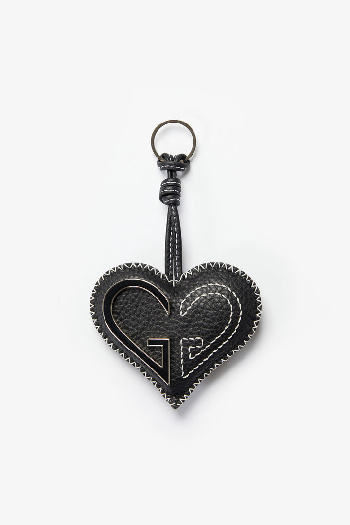Black heart-shaped keychain with a brand logo on a white background