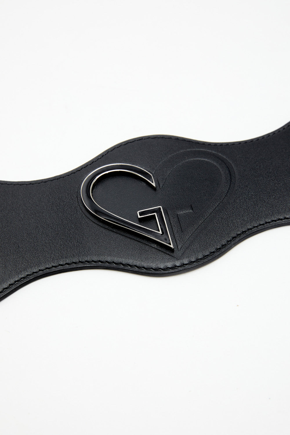 Black leather belt with a heart-shaped buckle on a white background