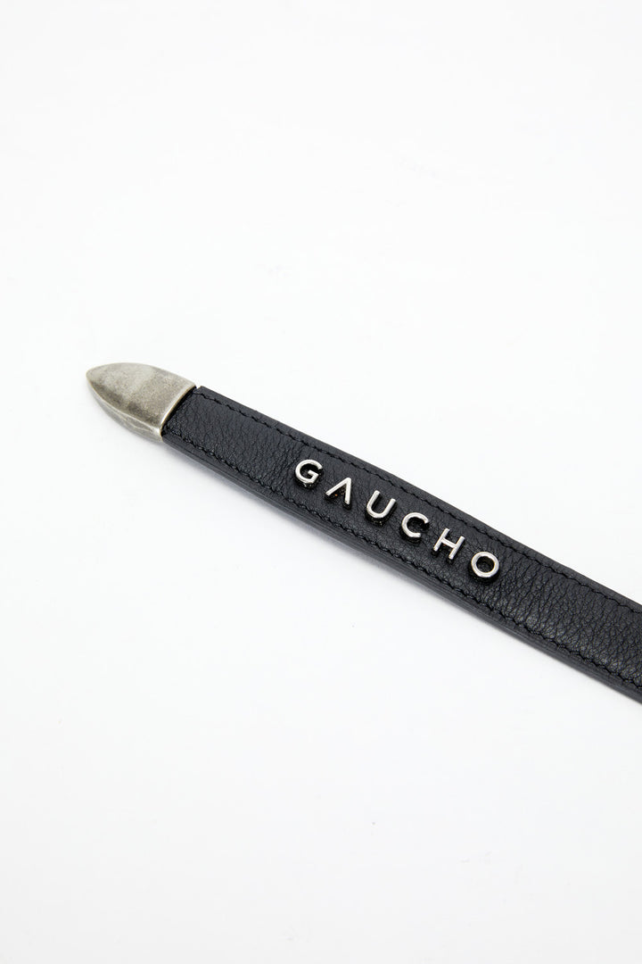 Black pen with silver cap on a white background, featuring the brand 'Gaucho'.