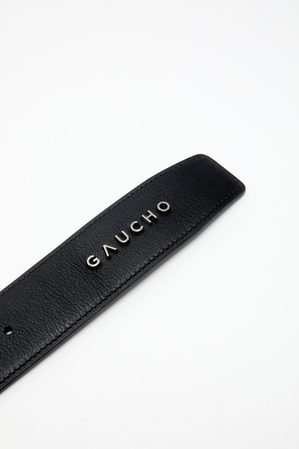 Black leather belt with 'Gaucho' branding on a white background