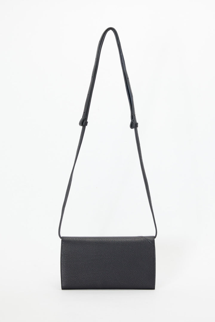 Black handbag with a strap on a white background