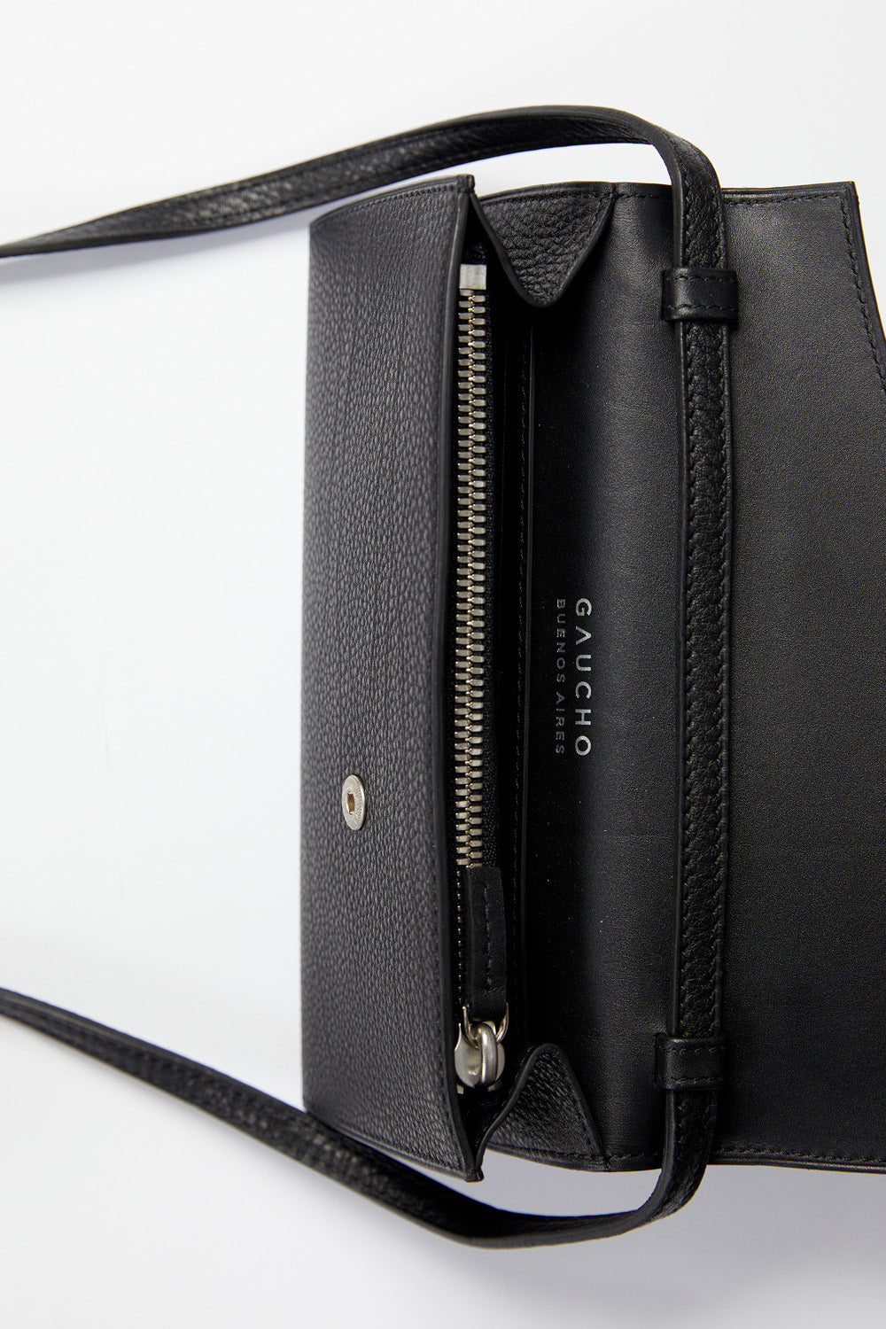 Black leather handbag with visible brand name on a white background