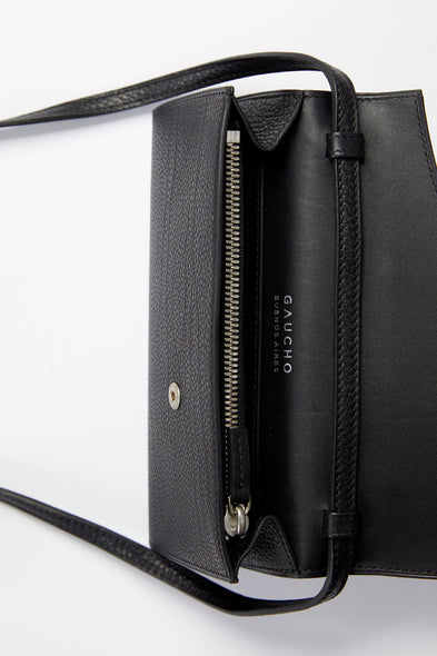 Black leather handbag with visible brand name on a white background