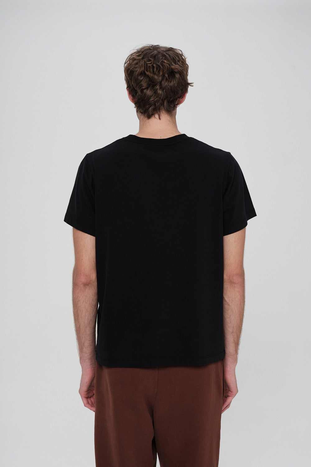 Person wearing a black t-shirt on a white background