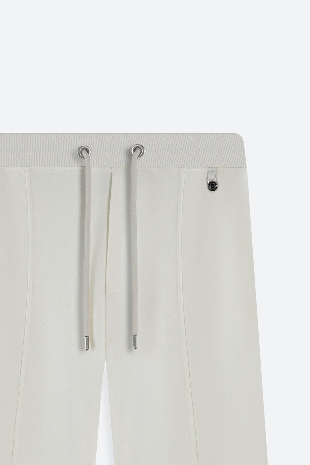 Off-white pants with drawstring details on a white background