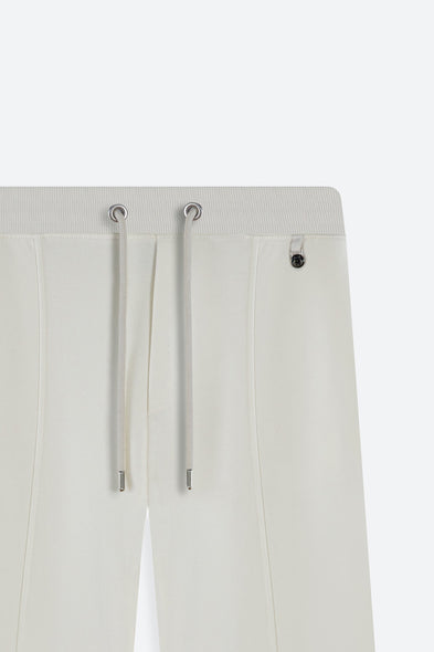 Off-white pants with drawstring details on a white background
