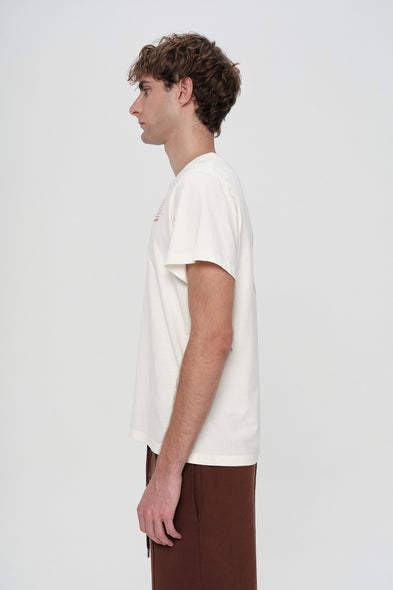 Person wearing a plain white t-shirt on a light gray background