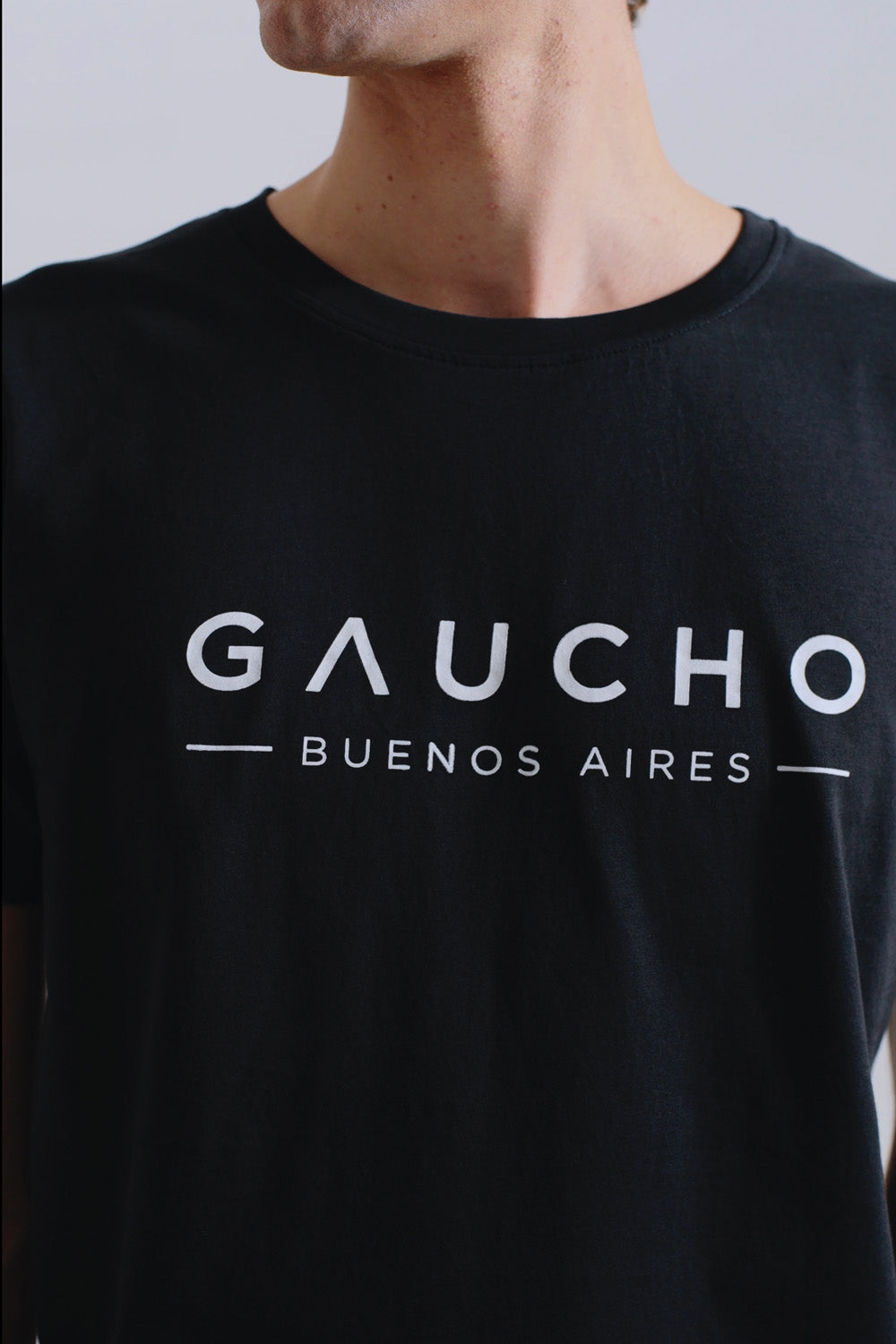 Black t-shirt with 'Gaucho Buenos Aires' text on a plain background