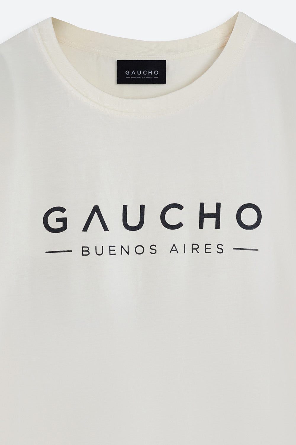 Close-up of a white shirt with 'Gaucho Buenos Aires' text and logo.