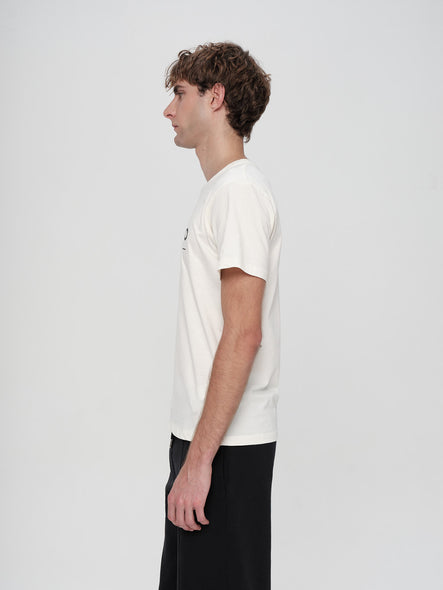 Person wearing a white t-shirt and black pants on a light gray background