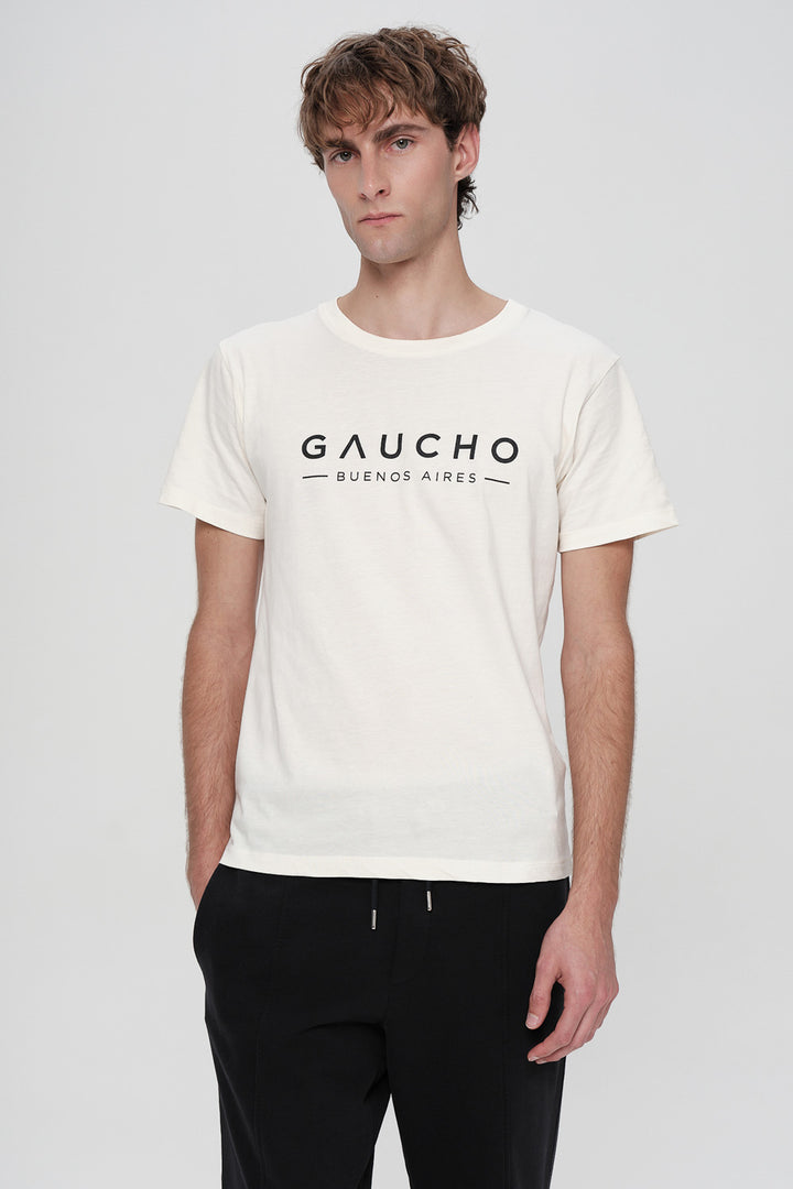 Man wearing a white t-shirt with 'Gaucho Buenos Aires' text on a plain background