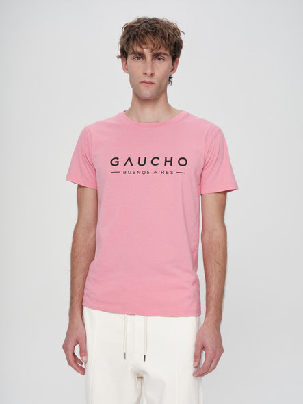 Person wearing a pink t-shirt with 'Gaucho Buenos Aires' text on a white background
