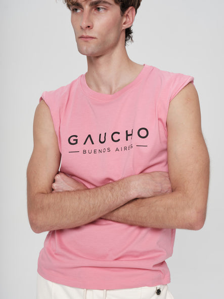 Person wearing a pink sleeveless shirt with 'Gaucho Buenos Aires' text on a white background