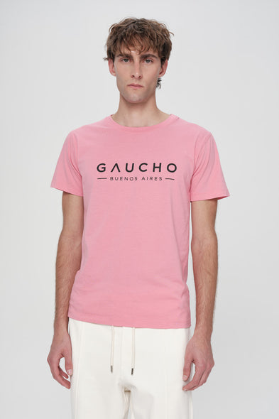 Person wearing a pink t-shirt with 'Gaucho Buenos Aires' text on a white background