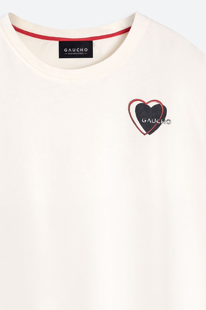 White t-shirt with a heart-shaped logo and 'Gaucho' branding on a white background
