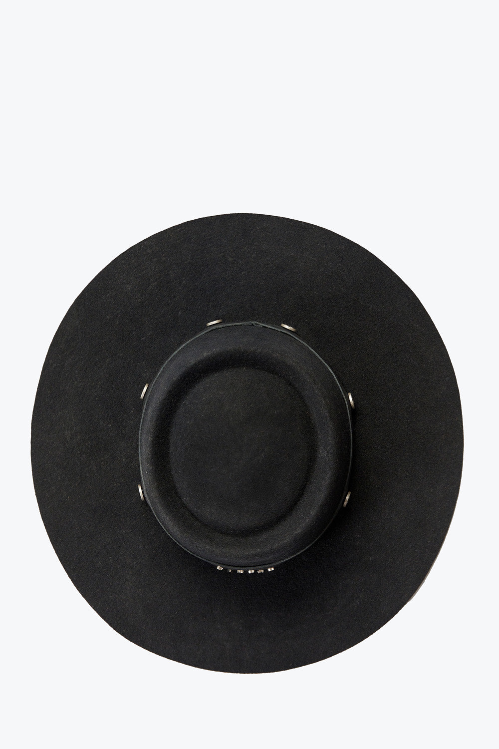 Black wide-brimmed hat on a light gray background