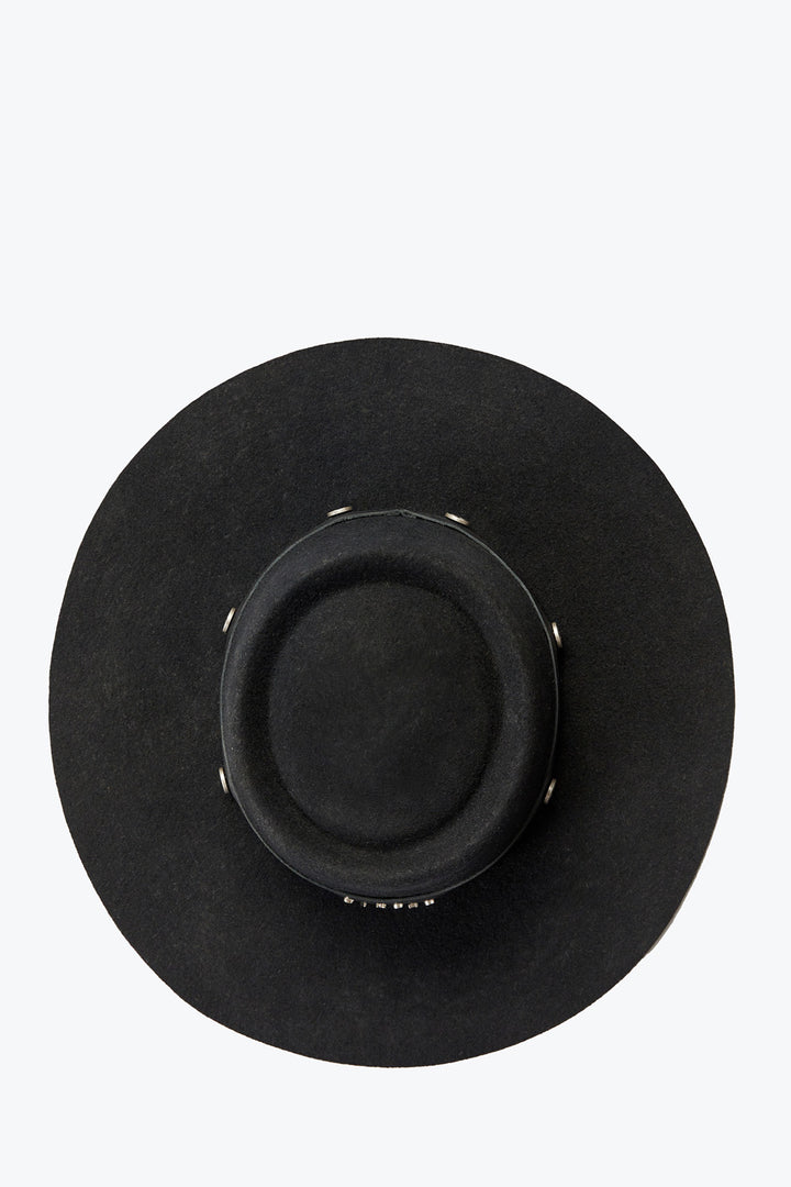 Black wide-brimmed hat on a light gray background