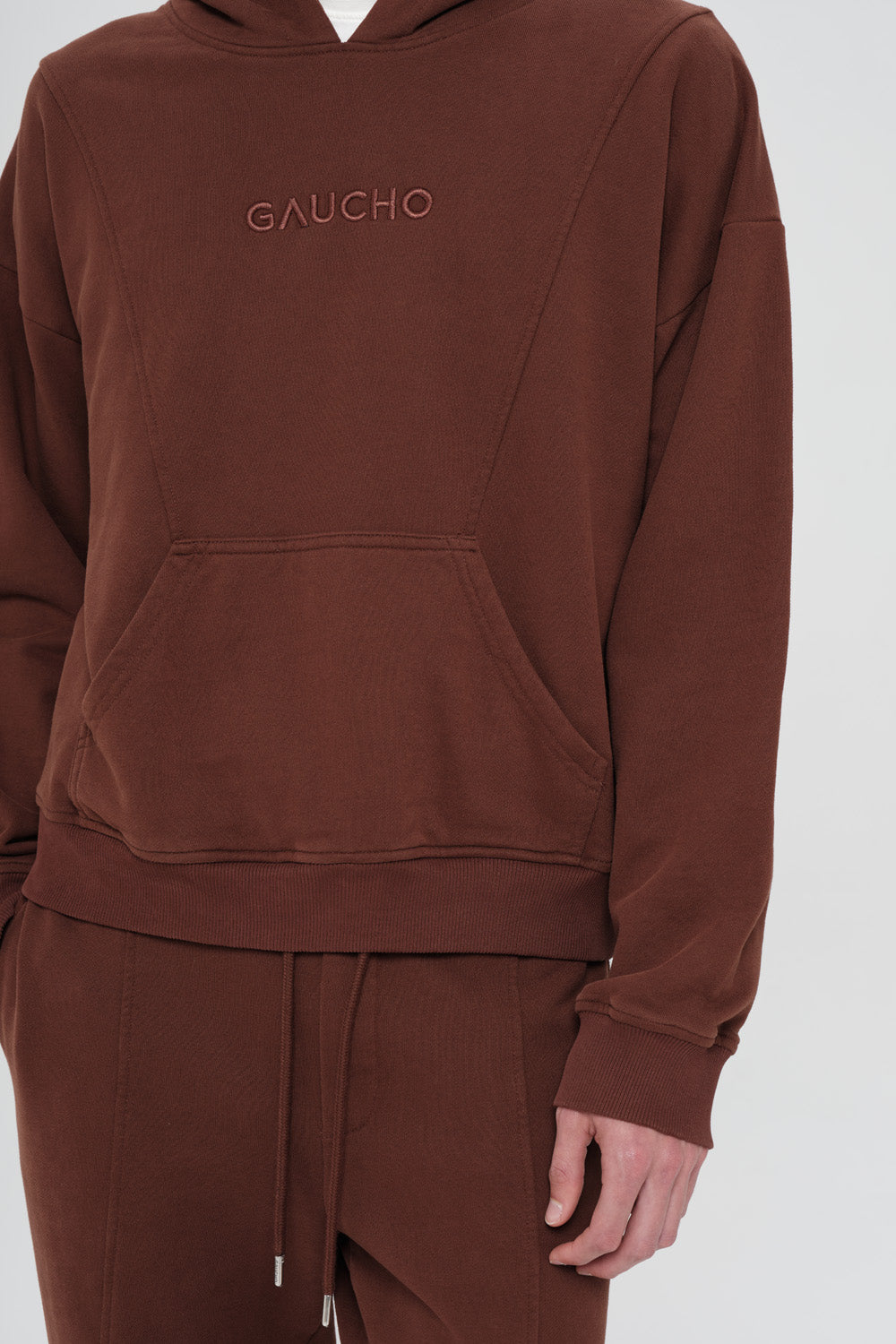 Brown hoodie with 'GAUCHO' branding on a white background