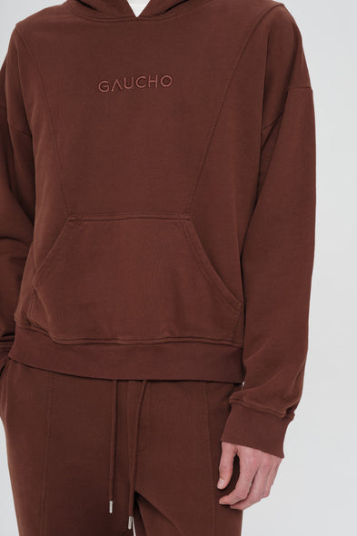 Brown hoodie with 'GAUCHO' branding on a white background