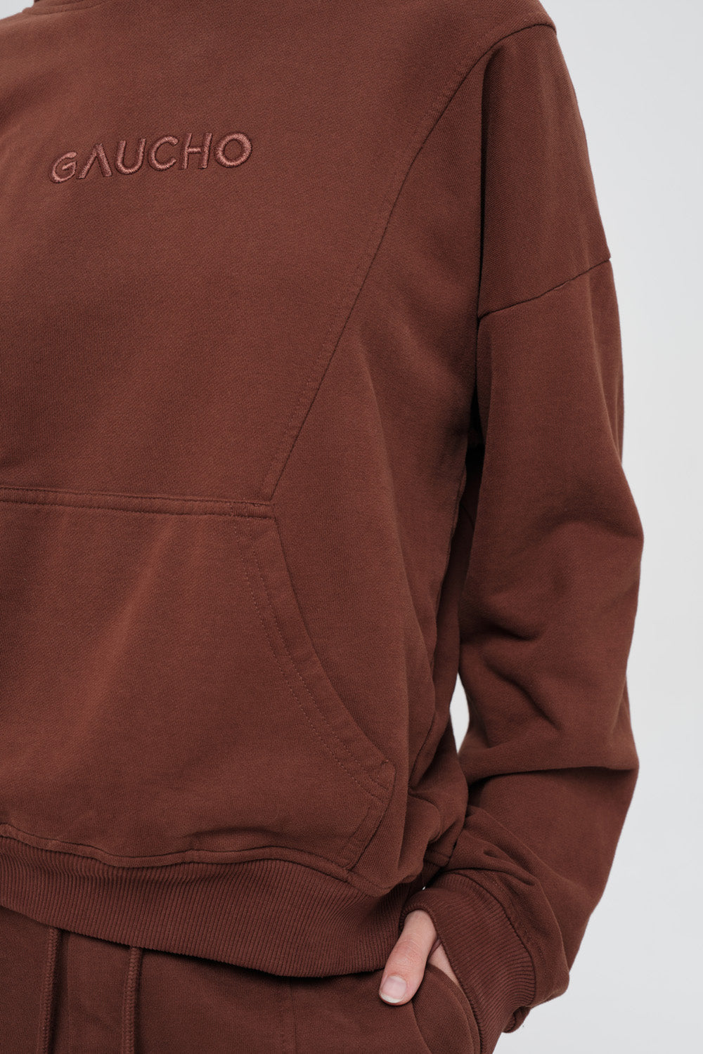 Brown hoodie with 'GAUCHO' branding on a white background