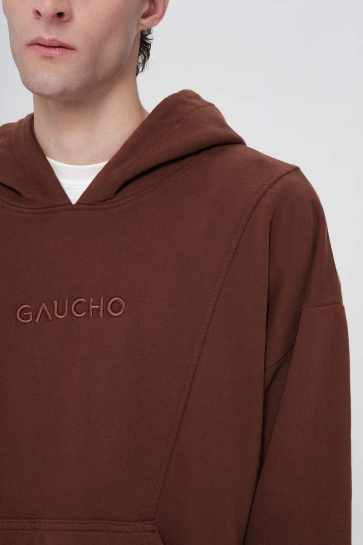 Brown hoodie with 'GAUCHO' branding on a white background