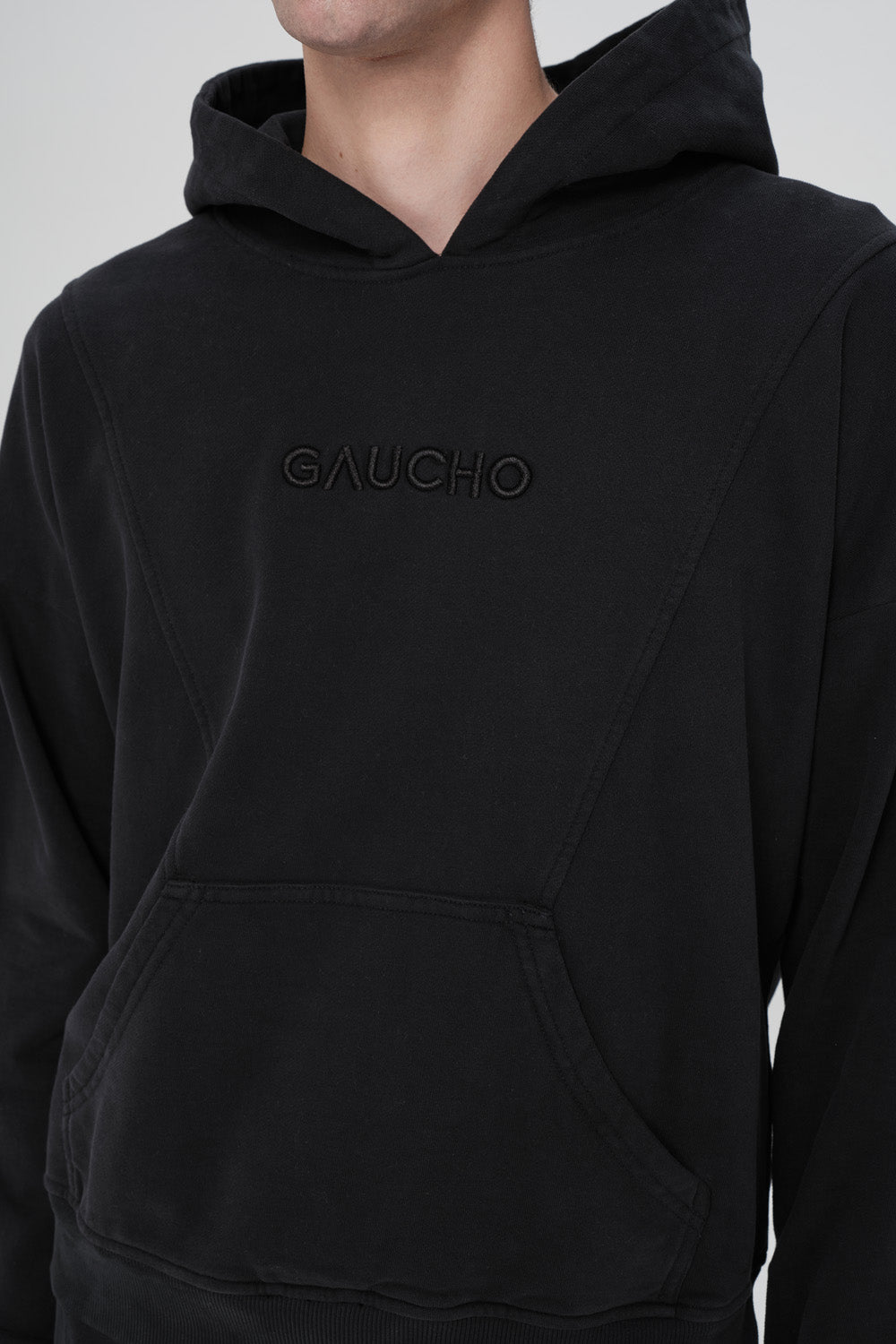 Black hoodie with 'GAUCHO' branding on a plain background
