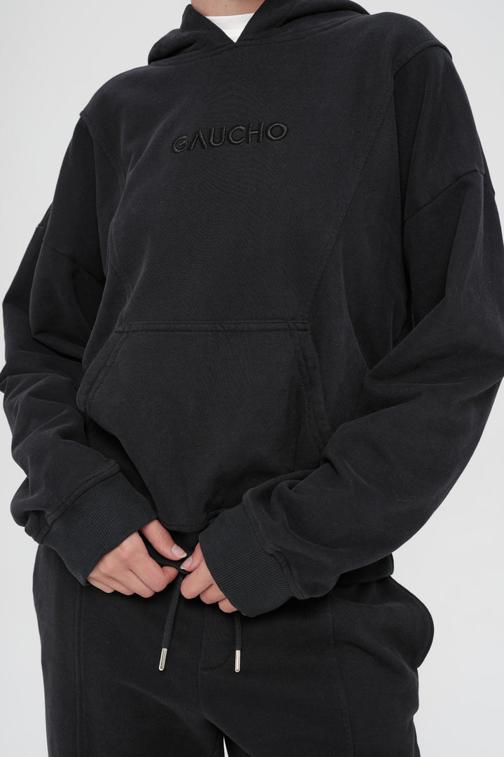 Black hoodie with 'Gaucho' branding on a white background