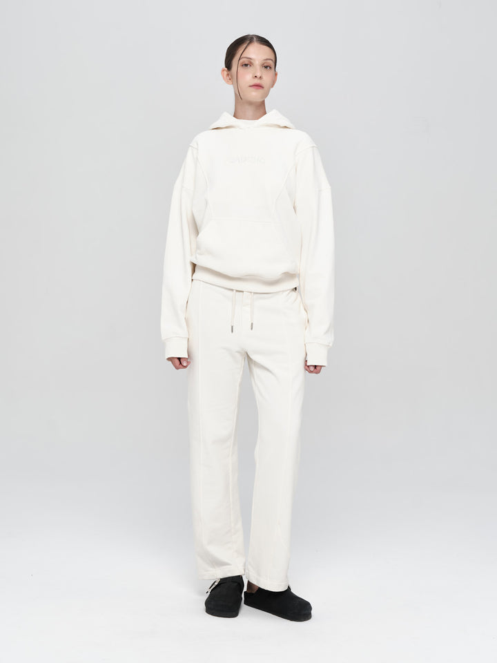 Person wearing a white outfit on a light gray background