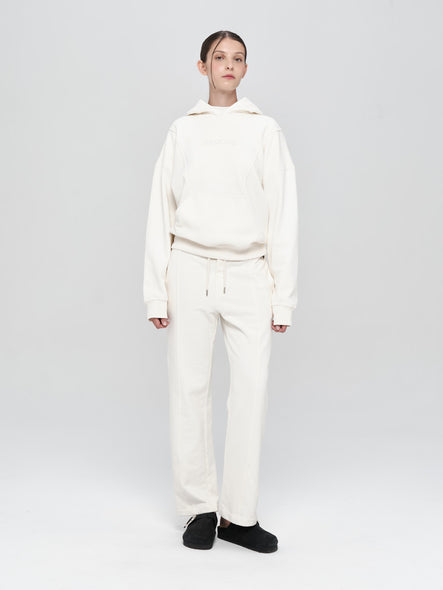 Person wearing a white outfit on a light gray background