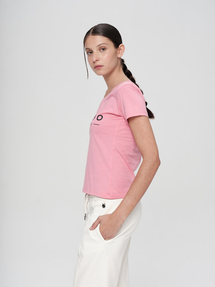 Person wearing a pink t-shirt with a logo on a white background