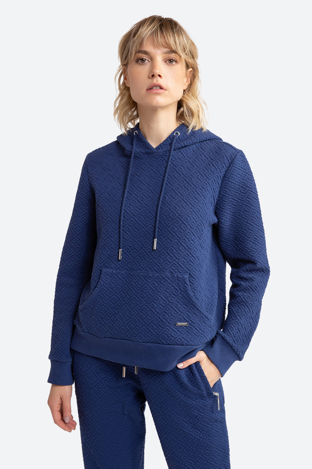 Woman wearing the Gorriti Gaucho Pattern Hoodie in Navy