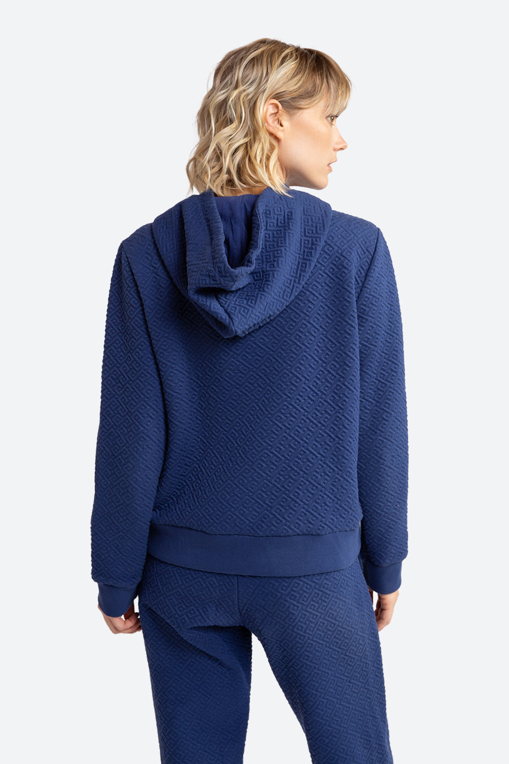 Woman wearing the Gorriti Gaucho Pattern Hoodie in Navy